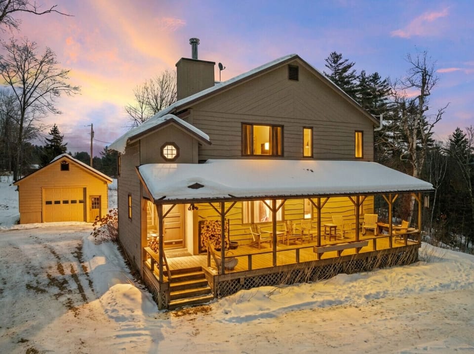 A cozy winter home glowing at sunset - tucked into Vermont quiet