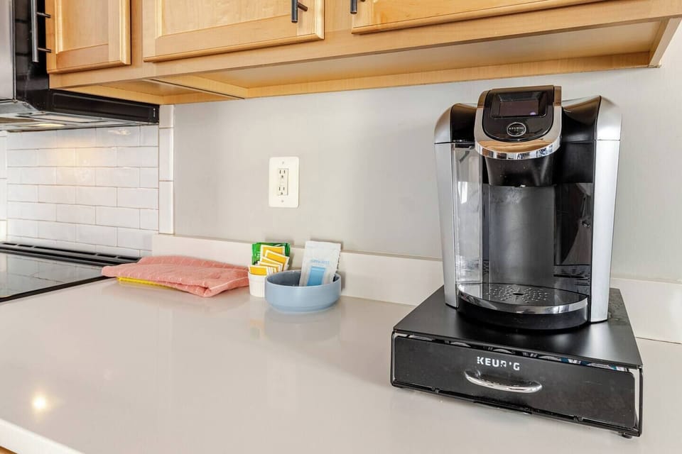 Keurig coffee station with starter K-cups, sugar, and creamer