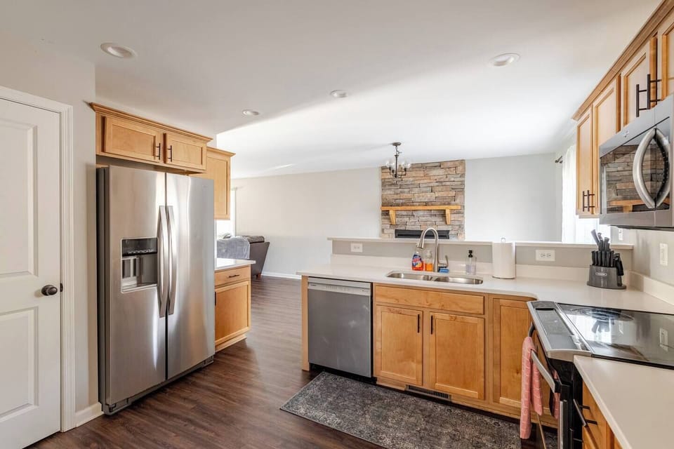Stainless side-by-side fridge and dishwasher — open to the great room