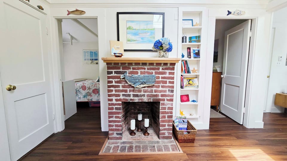 Decorative fireplace with doors to the bedrooms on either side