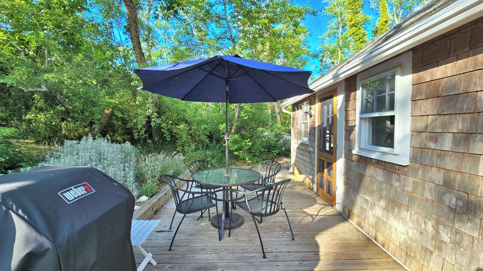 Cottage has a back deck with table, chairs, gas grill and enclosed outdoor shower