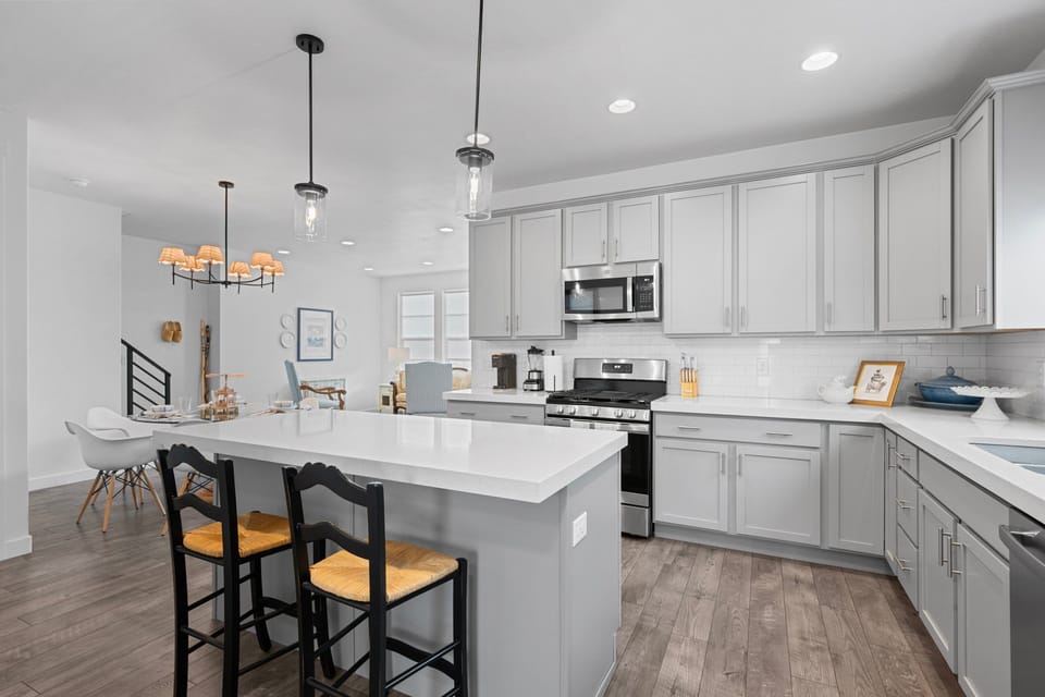 Large kitchen island with additional seating in a well appointed Chefs Kitchen