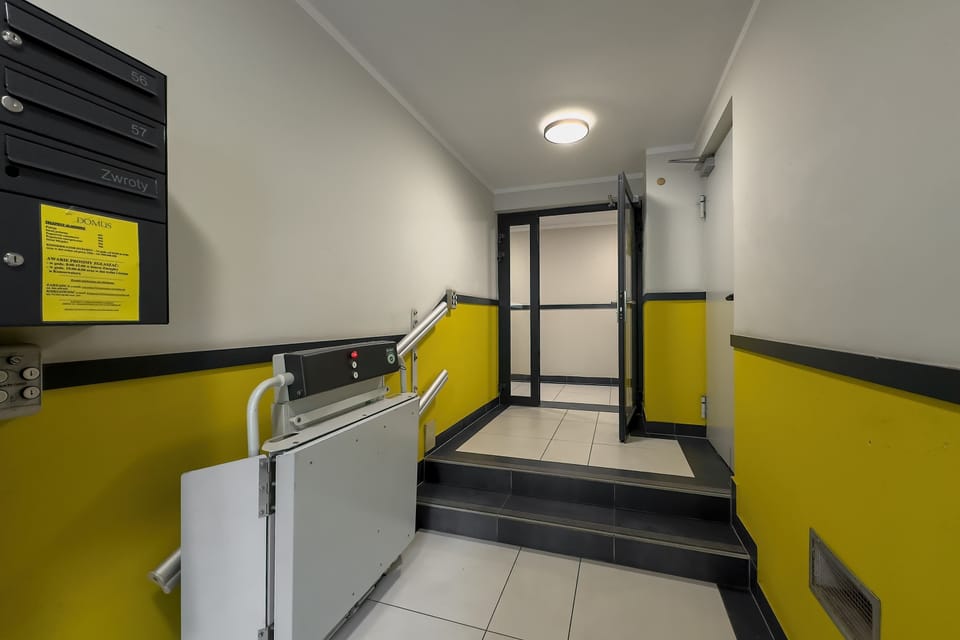 The building entrance with vibrant accents hints at the modern, well-kept interior.
