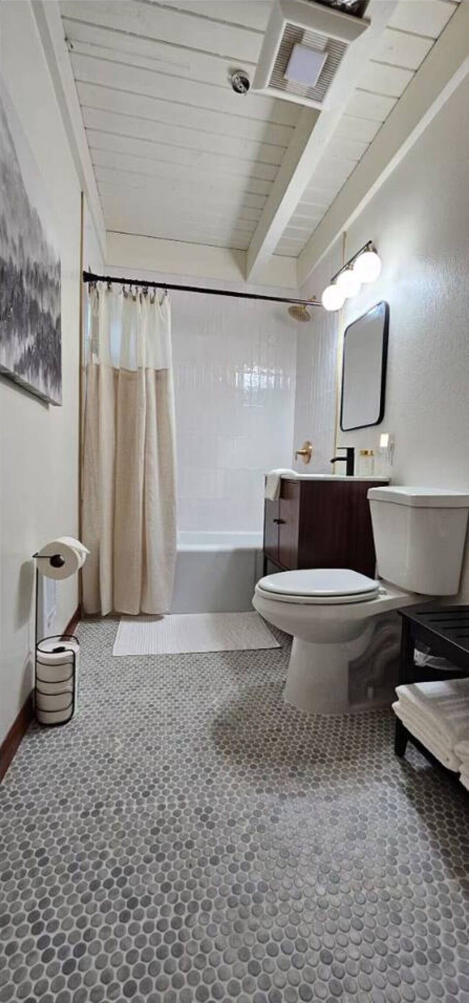 This clean, modern bathroom features a shower/tub combo, soft lighting, and everything you need to refresh after a day of adventure.