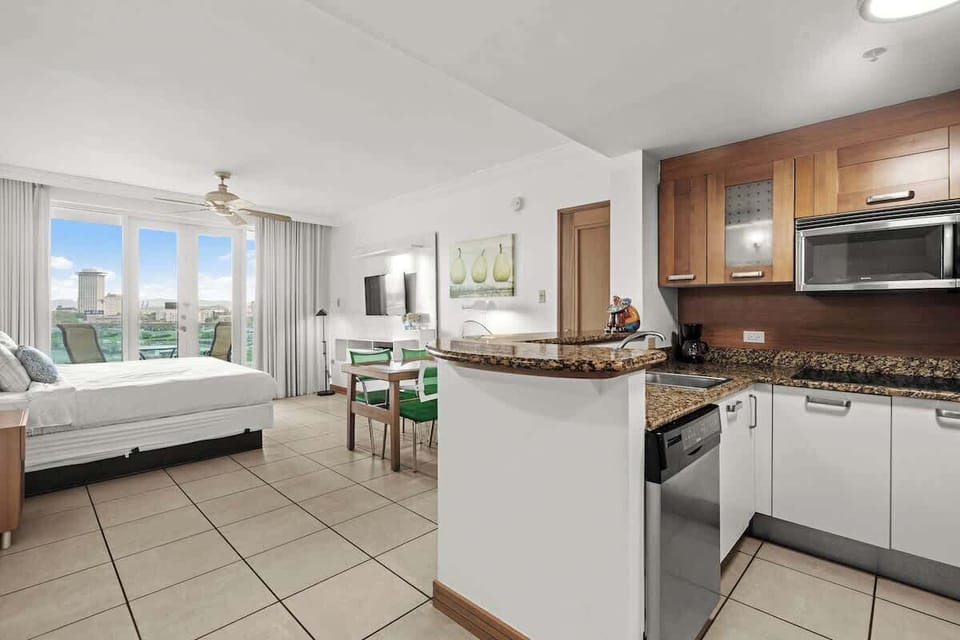 Experience the best of open-concept living in this inviting studio. From the fully equipped kitchenette and comfortable bed to the dining area and stunning balcony views, every element is curated for a delightful and memorable stay.