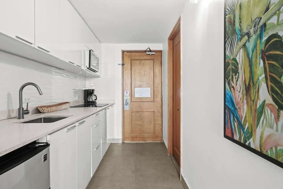 Enter a bright and welcoming space, where modern design meets practicality. Our sleek kitchenette, complete with essential appliances, is immediately accessible, making arrivals smooth and your stay effortlessly comfortable.