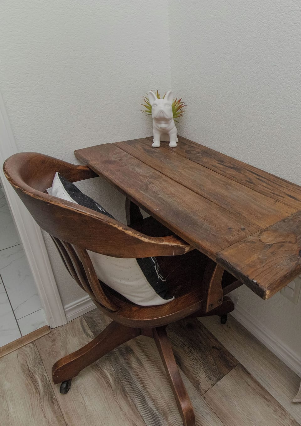 Cozy rustic desk nook w/vintage chair; perfect for remote work. 