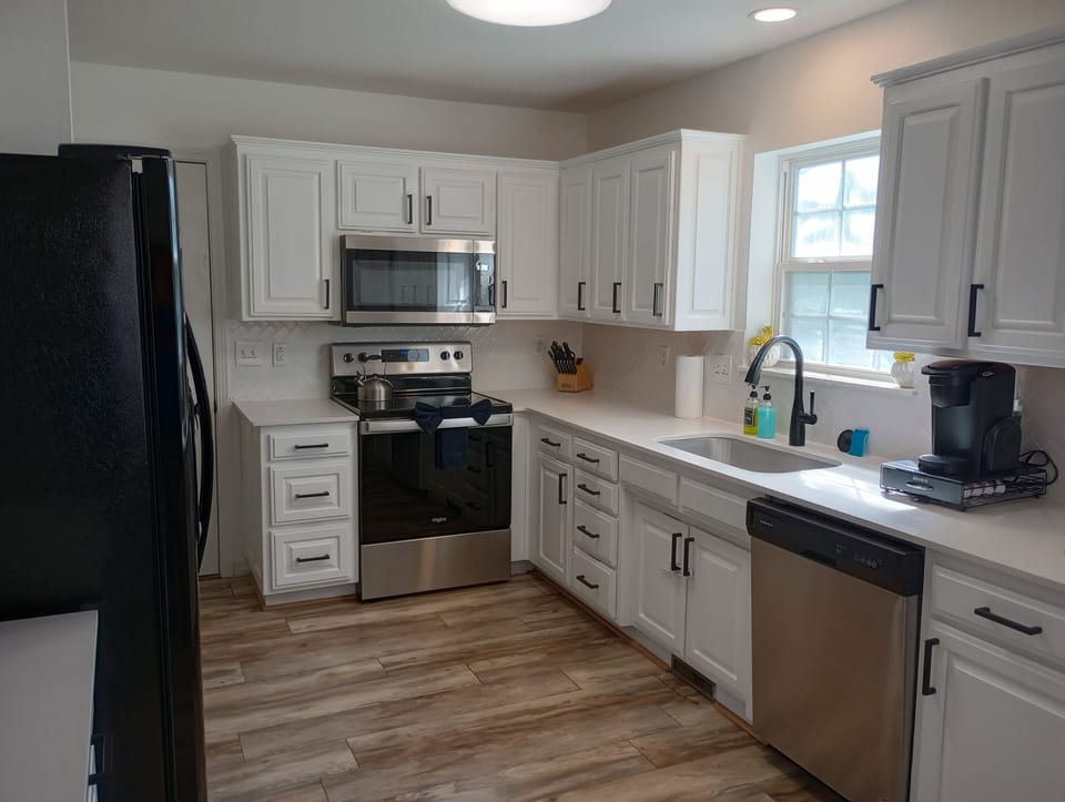 White cabinetry and sleek stainless steel appliances make up this modern kitchen