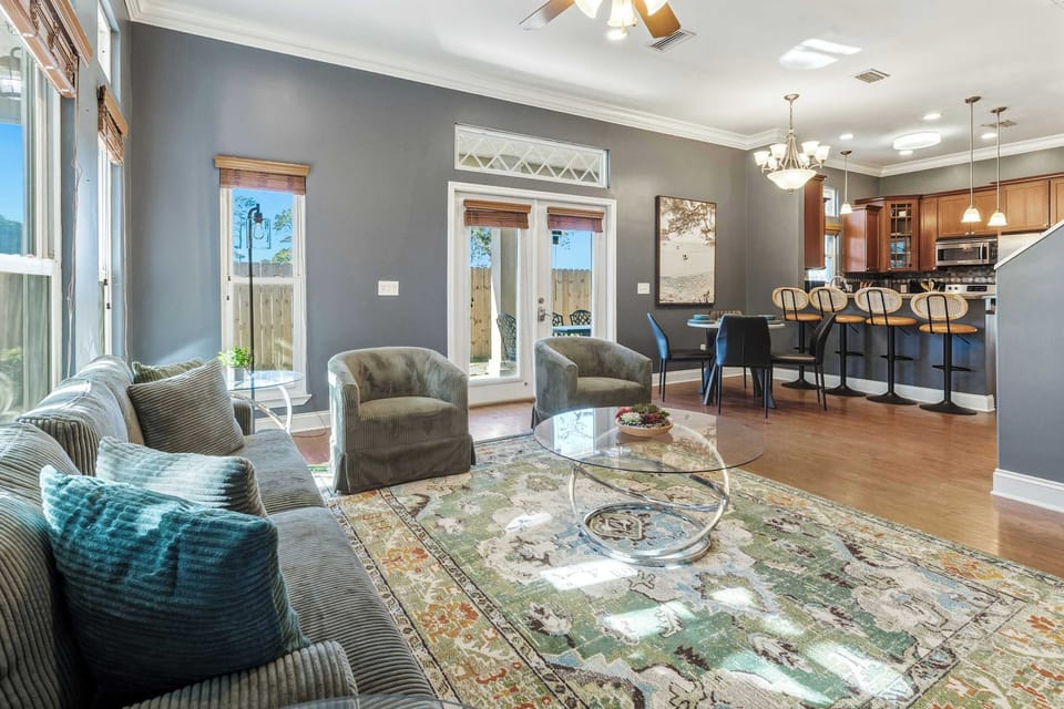 Cozy living room with patio doors, dining area & kitchen near the beach