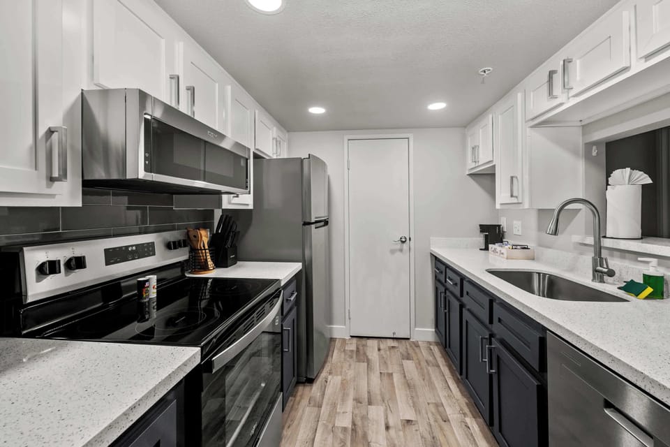 Functional kitchen with oven, stove, fridge and basic cooking ware