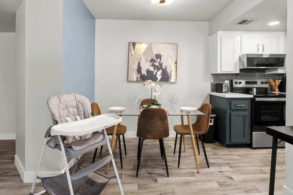 Elegant dining area with seating for four, plus a high chair for added convenience.
