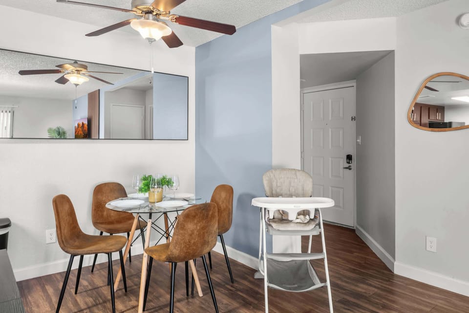 Elegant dining area with seating for four, plus a high chair for added convenience.