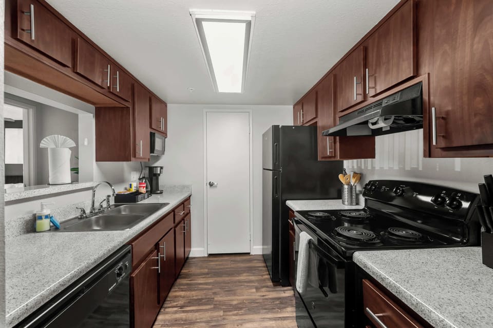 Prepare meals comfortably with ample counter space and cookware provided.