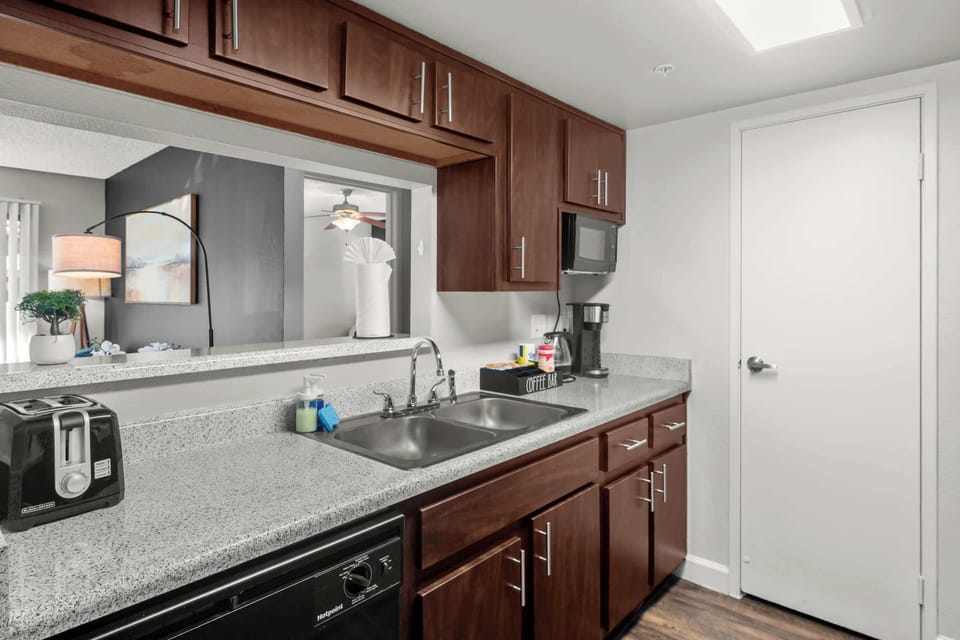 A clean, functional sink area with ample upper cabinet storage.