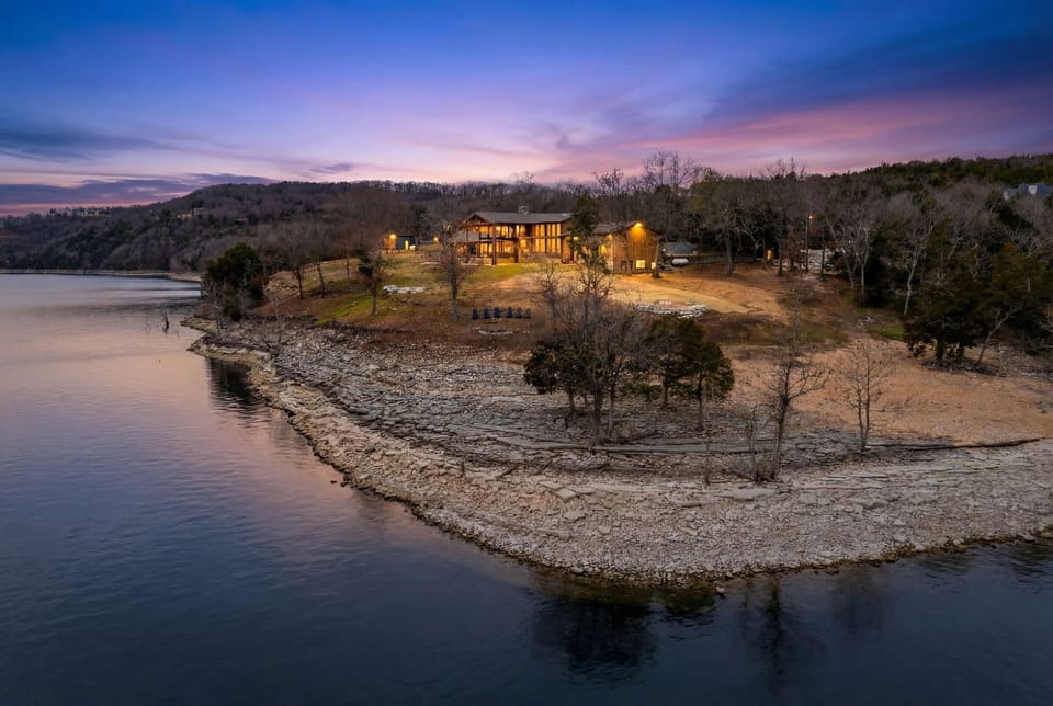 True lakefront retreat on Table Rock Lake with direct shoreline access and breathtaking sunset views.