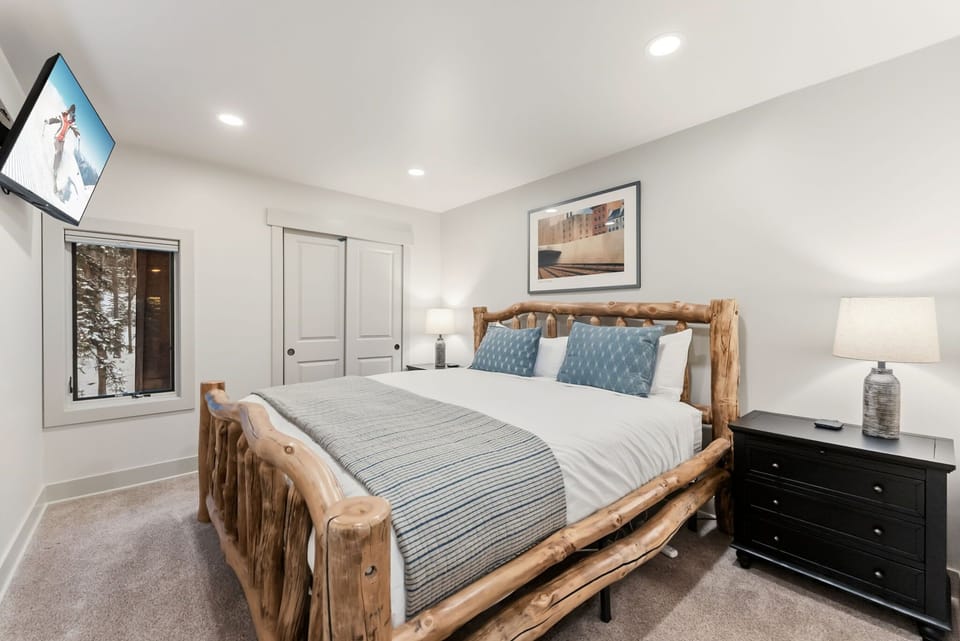 King bed with a TV on the upper level of the home.