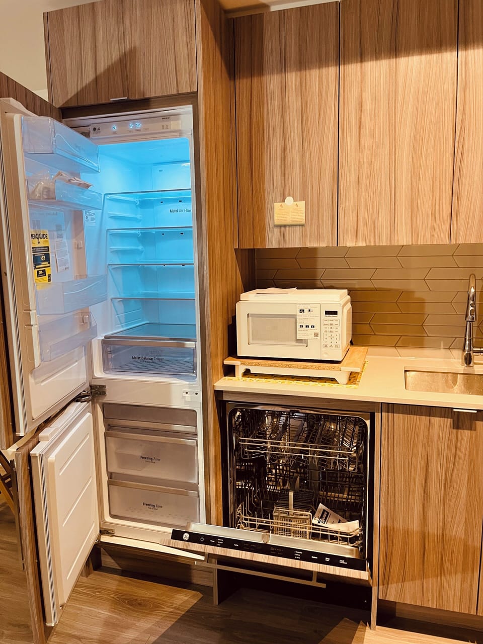 Fully equipped kitchen with new appliances and a microwave,