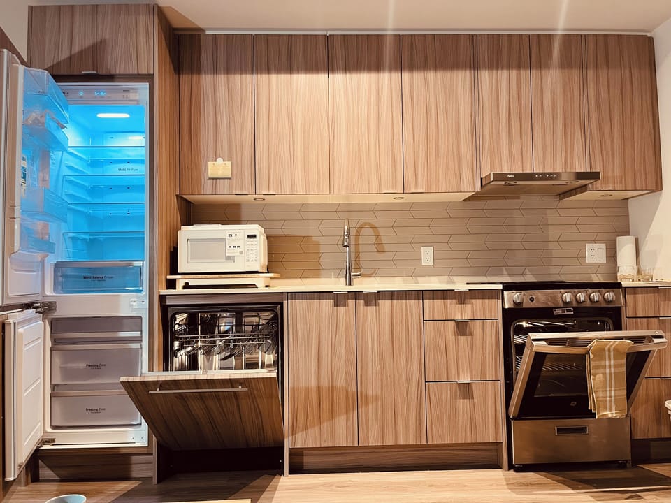 Modern kitchen, including new appliances and a microwave.