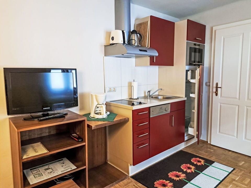 Furniture, Interior Design, Wood, Flooring, Floor, Cabinetry, Room, Major Appliance, Countertop, Kitchen