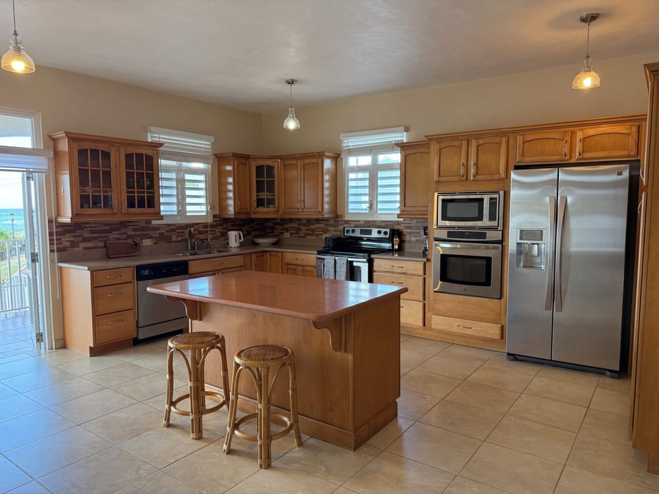 Full kitchen w/ ice maker, cups, dishes, silverware, pots & pans for cooking