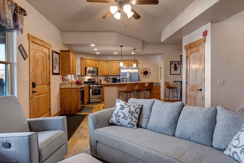 Unwind in your spacious living area where rustic wood meets modern comfort, perfect for gathering after mountain adventures.
