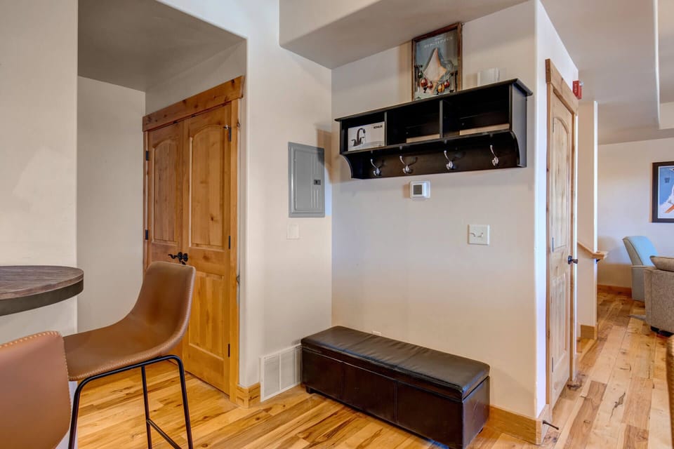 Step into your welcoming entryway where warm wood floors and thoughtful touches create the perfect arrival experience.