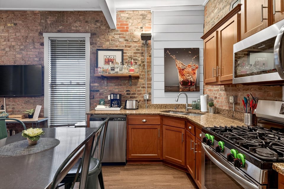Our kitchen is fully stocked with stainless steel appliances and a gas range for gourmet meals. The wooden cabinetry provides ample storage for all your grocery needs.