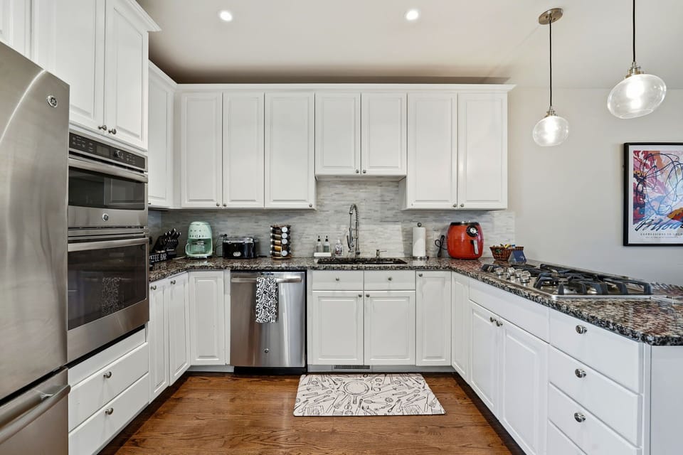 Clean, modern counters w coffee setup for easy starts and relaxed mornings in.