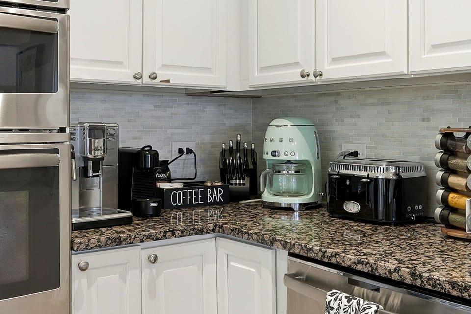 Clean, modern counters w coffee setup for easy starts and relaxed mornings in.