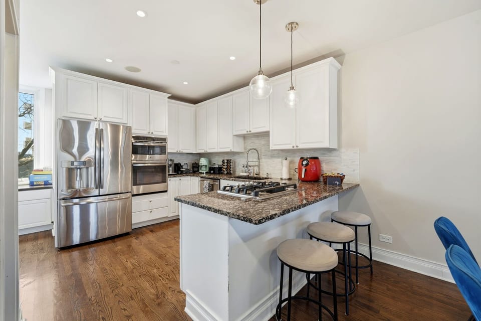 Kitchen angle showing ample prep space and an easy flow into dining and living areas.