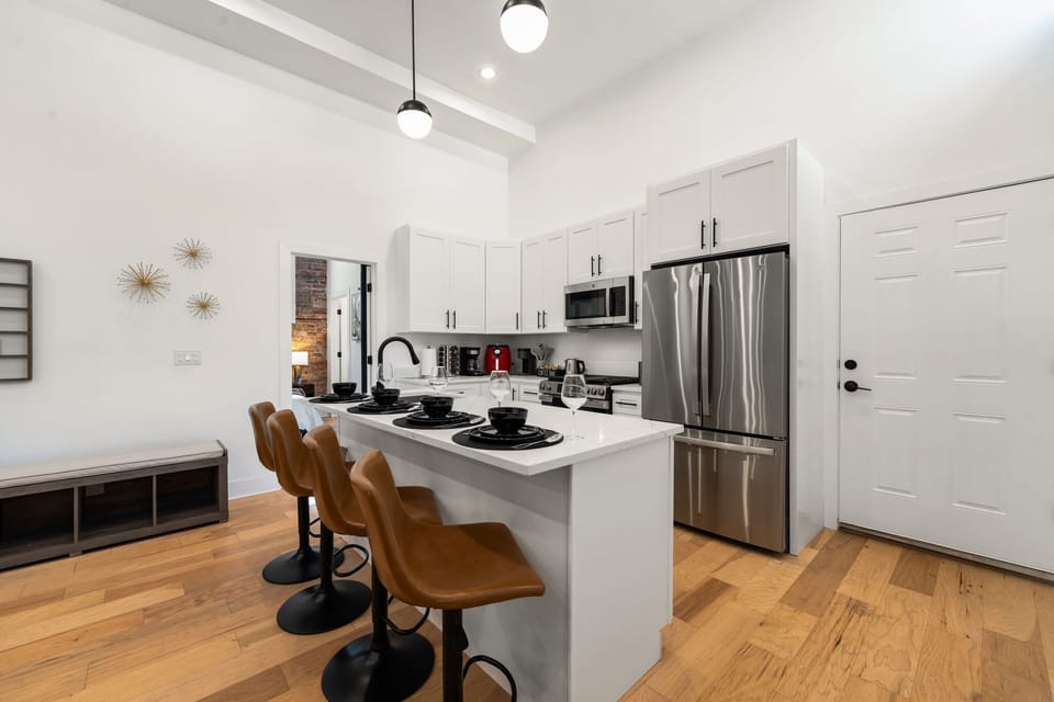 Sleek kitchen w/ bright finishes & plenty of room to cook together.