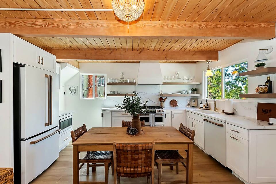 Eat in kitchen with extra chairs is a light and airy space for mealtime.