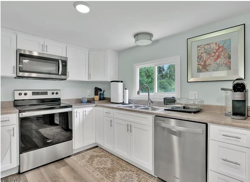 Fully equipped kitchen with stainless steel appliances, Keurig coffee maker, and everything you need for home-cooked meal