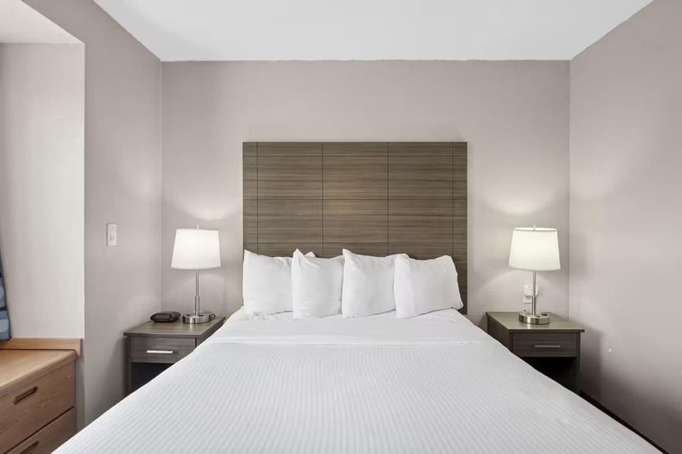 Drift off on crisp linens with warm bedside lighting.