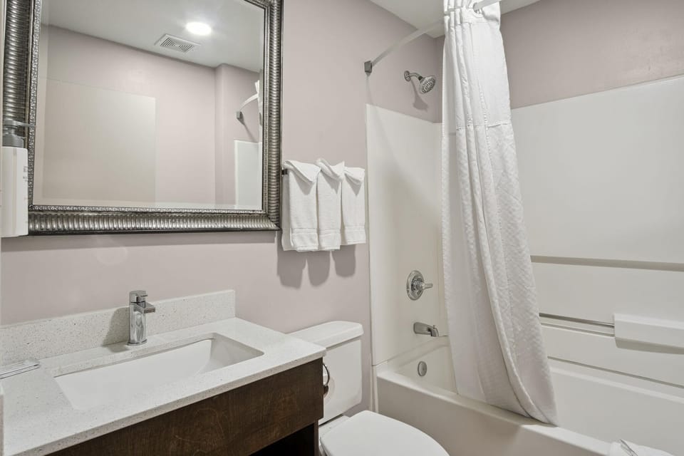 Refresh with a bright vanity and clean shower-tub combo.