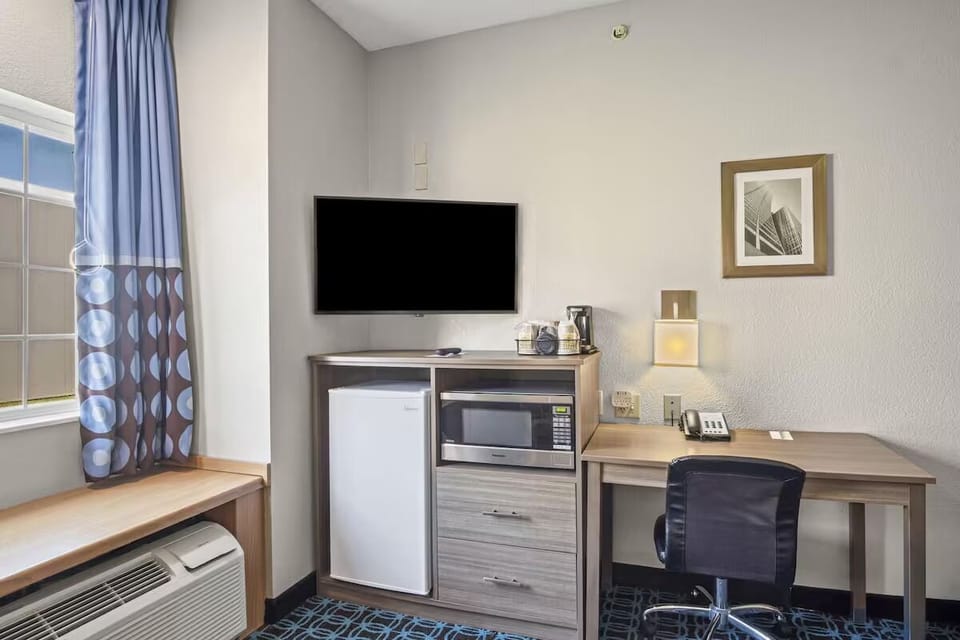 Catch up on work with a desk, fridge, and microwave.