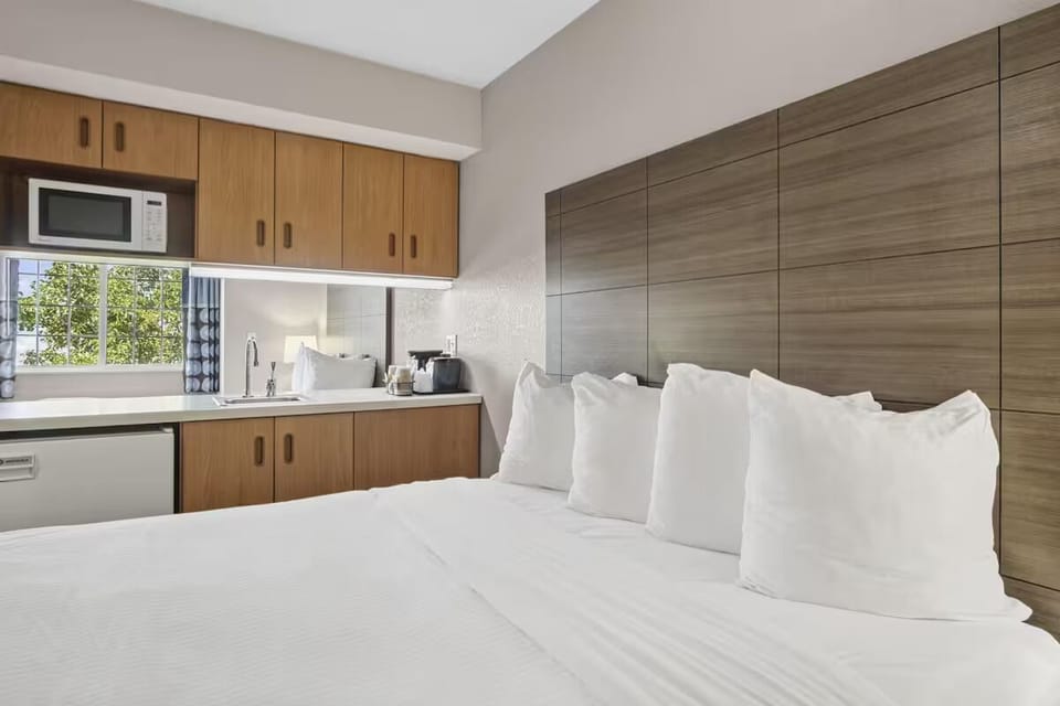 Unwind in crisp linens beside your in-room kitchenette.