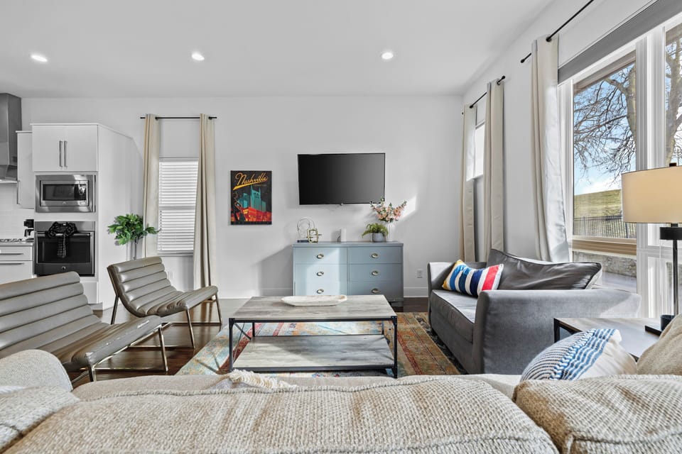 Mounted TV at optimal height, balanced seating arrangement, and warm...