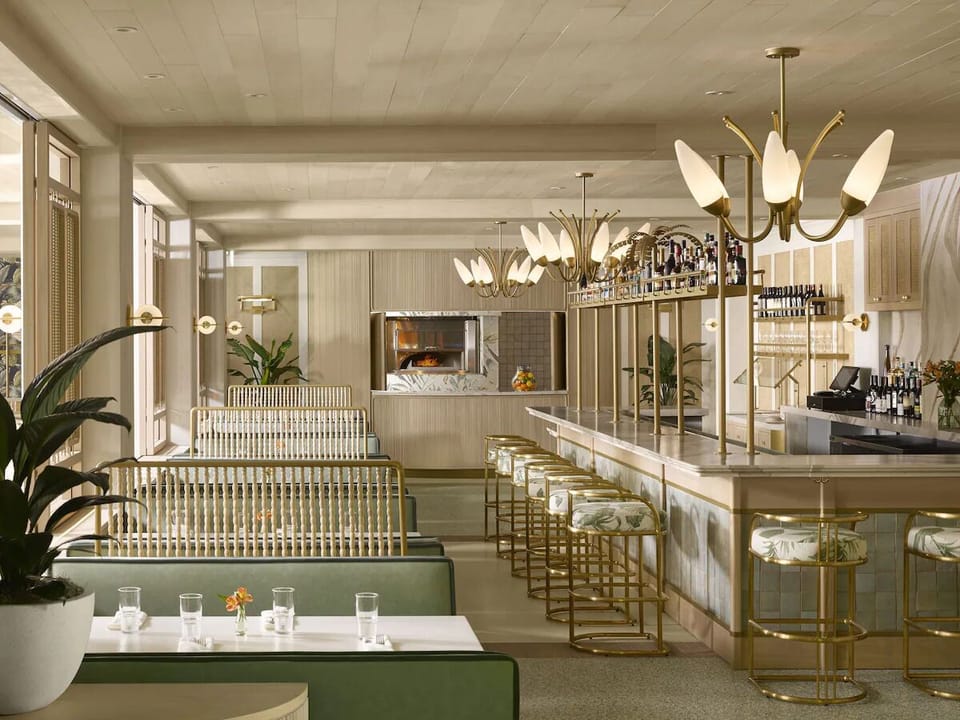 Sip craft cocktails at the sleek bar with plush seating.
