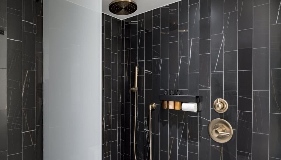 Rinse off in a sleek rain shower with modern tilework.