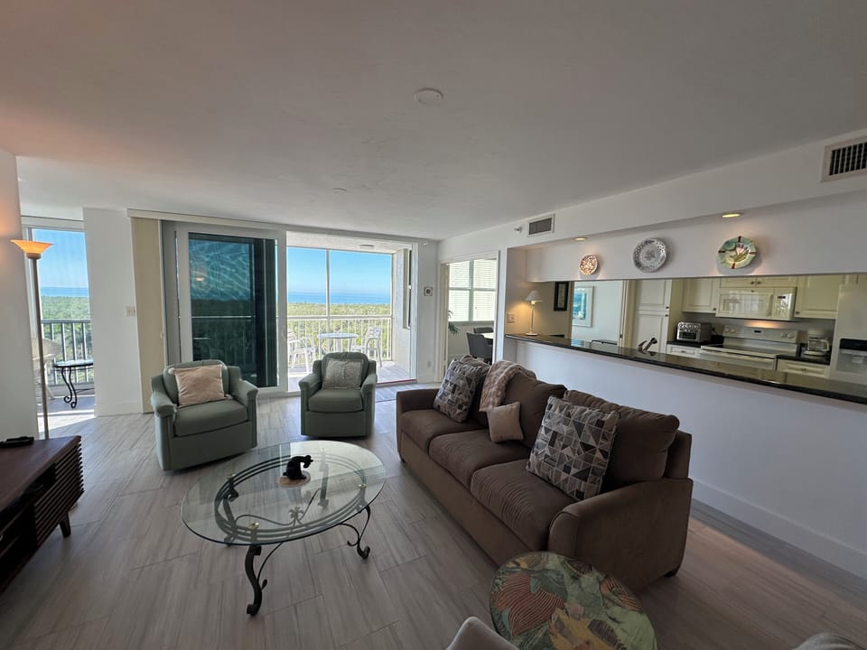 Living Room with views of the Gulf, and spacious Galley Kitchen w/Black Granite