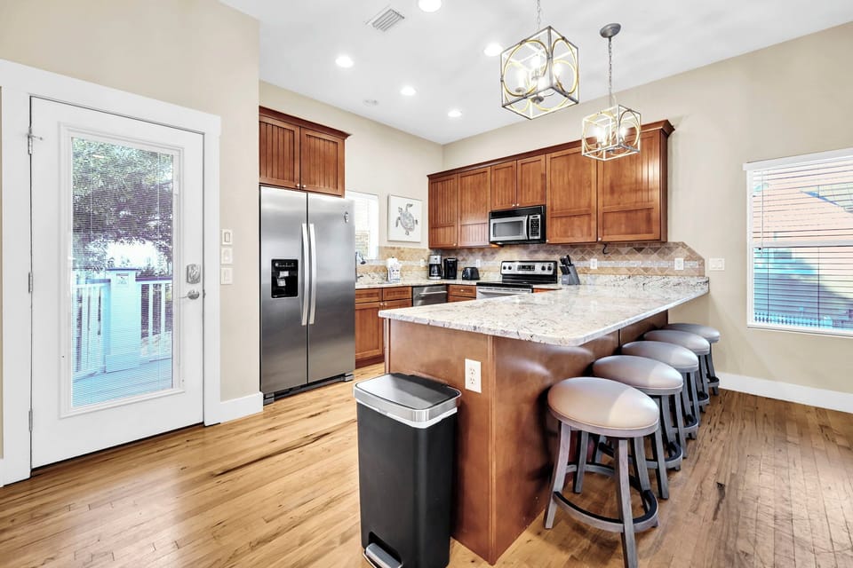 Your fully-equipped kitchen features granite countertops, stainless appliances, and a breakfast bar where you can gather with friends over morning coffee.