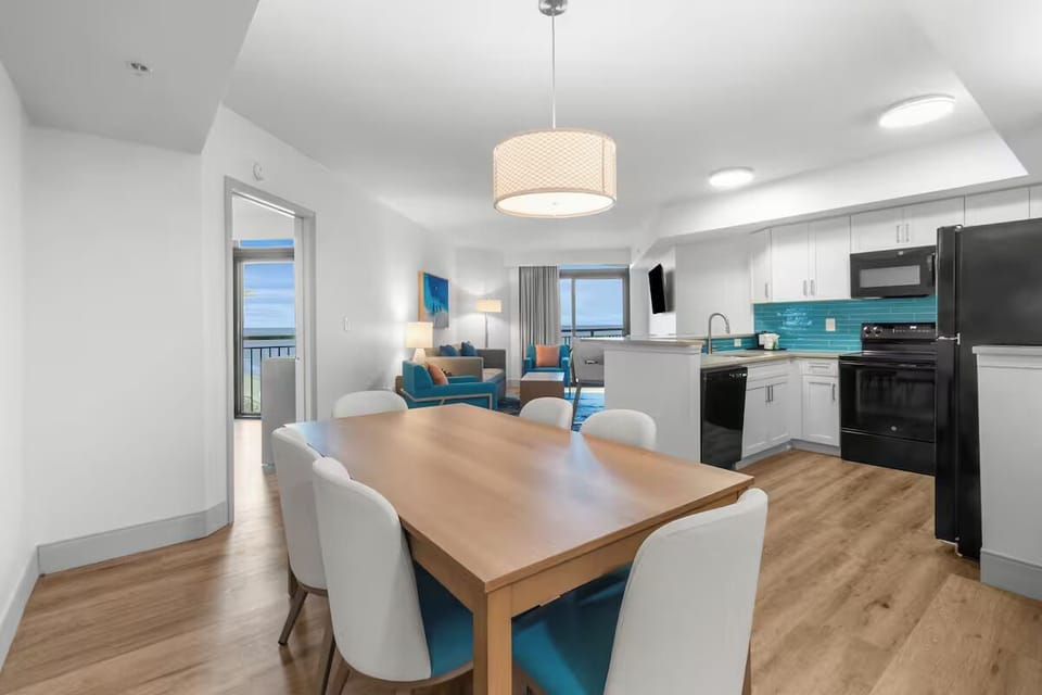 Enjoy open-plan living with ocean glimpses beyond the dining table.