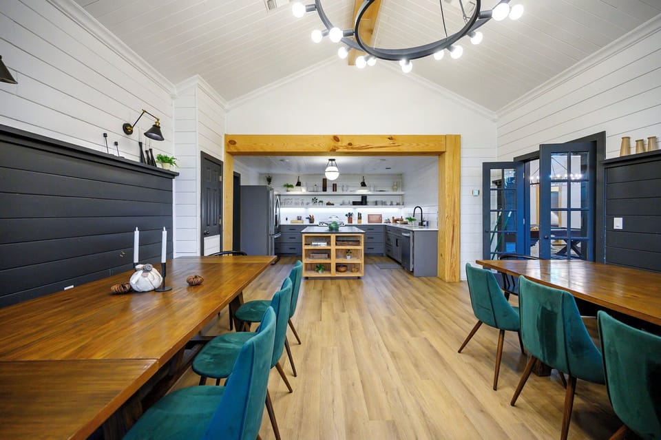 Gather around the elegant dining table where warm wood meets modern design, creating the perfect space for memorable meals together.