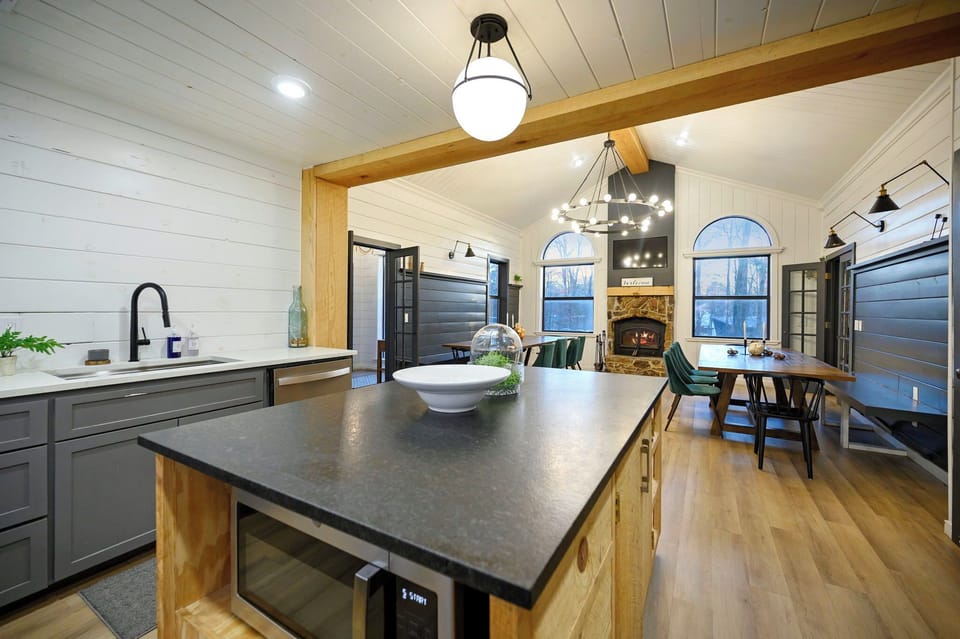 Your spacious kitchen flows seamlessly into the dining area, with modern appliances and a cozy fireplace creating the perfect gathering space.