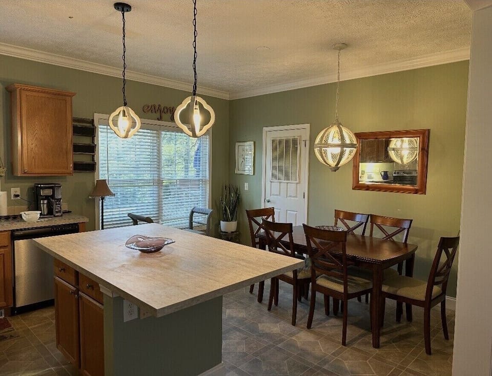 Sunny dining area with pond view and plenty of room for family