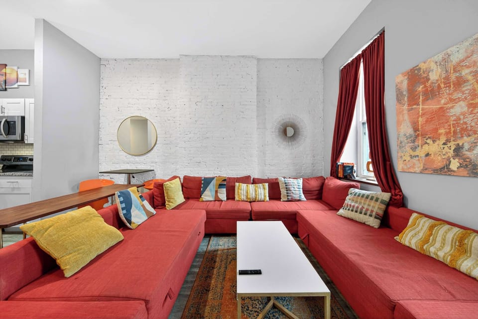 This vibrant living room, featuring a cozy red couch and a chic coffee table, is the perfect spot to unwind after a day of exploring. Imagine sipping your morning coffee here or curling up with a good book.Ready to make this your home away from home?