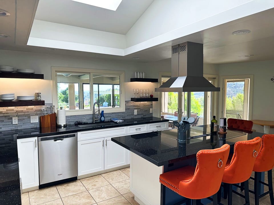 Villa kitchen with view of sunroom and pool area