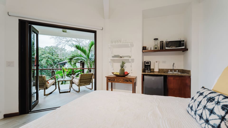 Bedroom with two queen beds and wet bar with microwave, coffee maker, and small refrigerator