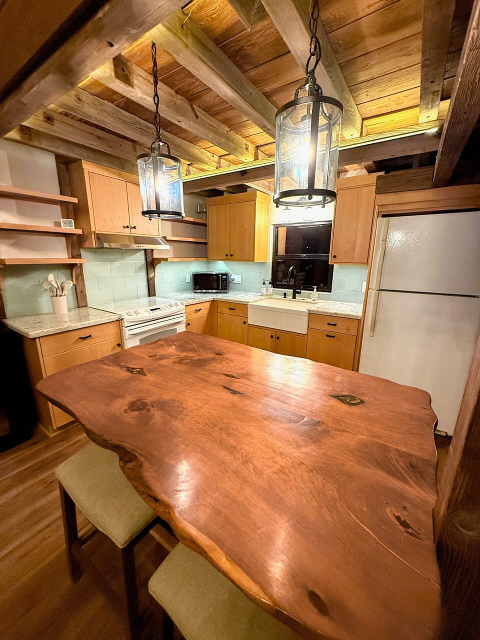 Completely stocked kitchen includes island and table seating.